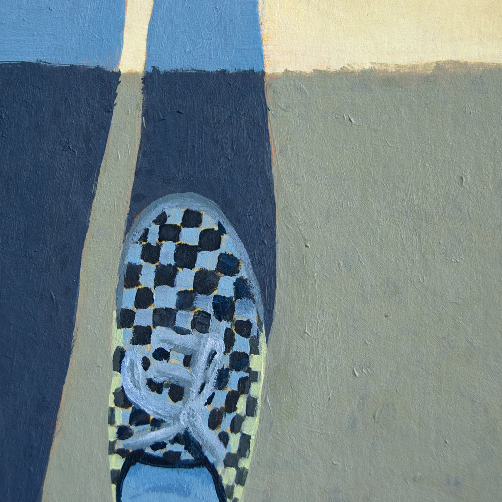 Close-up of a shoe with a checkered pattern on a multicolored background