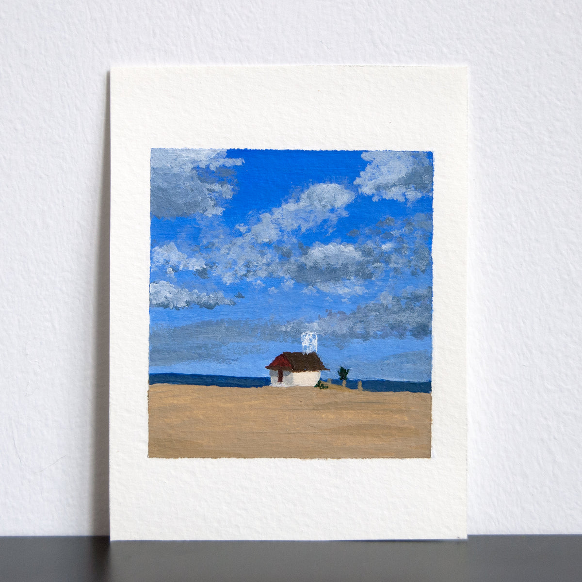 Artwork of a lifeguard station against a blue sky with clouds.